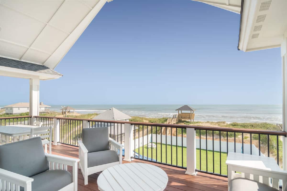 Just step outside to this fantastic water view covered deck with ocean breezes from the kitchen in Nags Head by SAGA