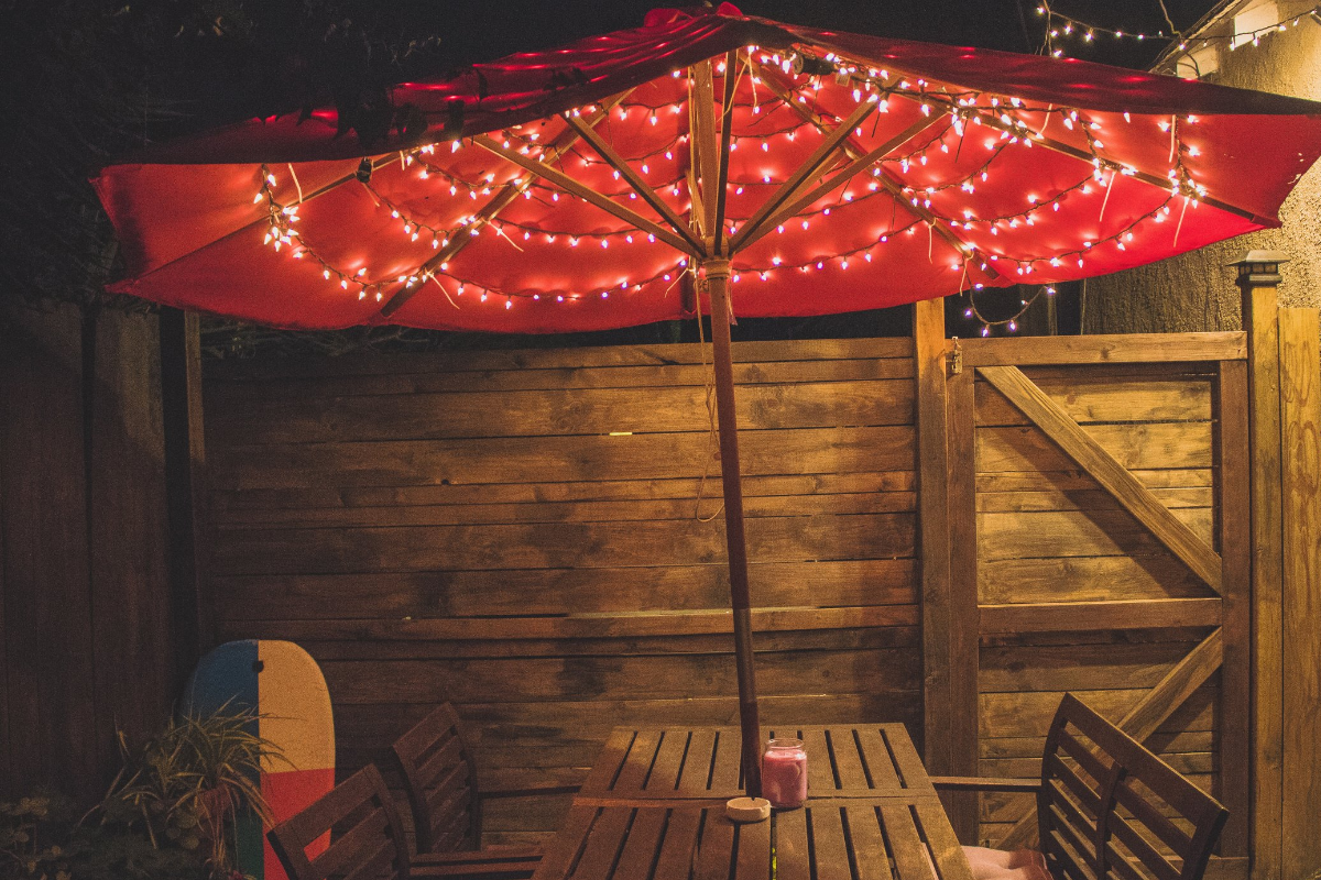 string lights on umbrella for backyard entertaining outer banks by SAGA